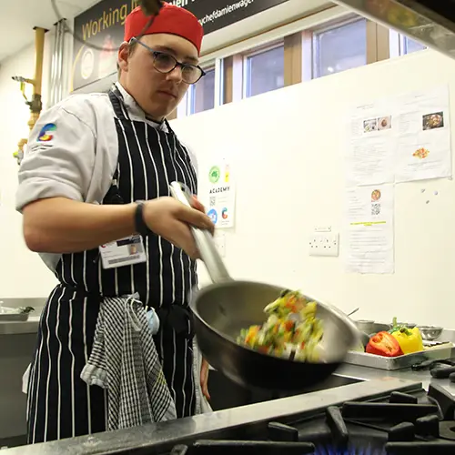 Catering student preparing food