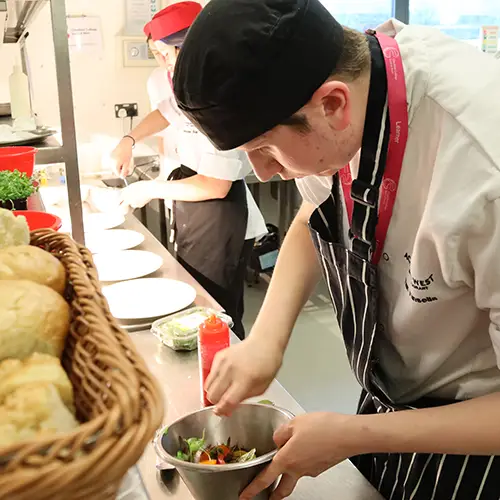 Catering student preparing food