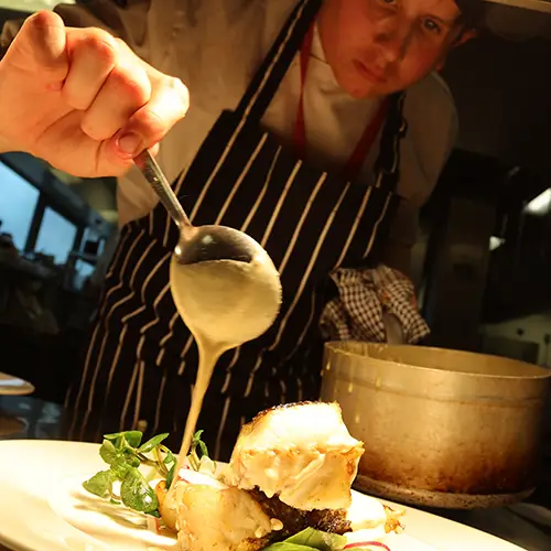 Catering student preparing food