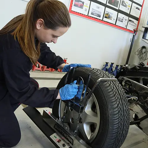 Motor Vehicle student checking wheel alignment