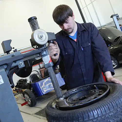 Motor Vehicle student fitting a tyre