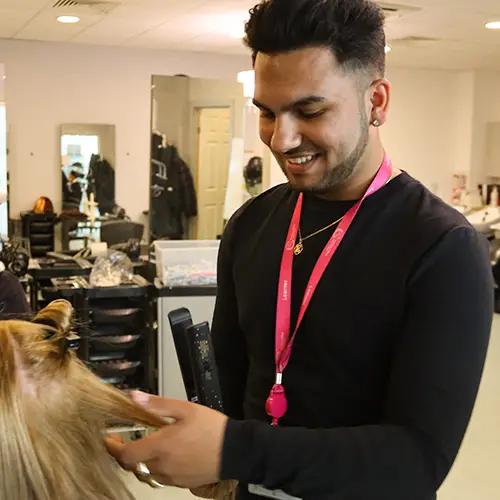 Hairdressing student styling hair