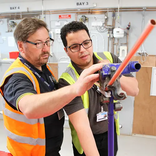 Plumbing student with tutor
