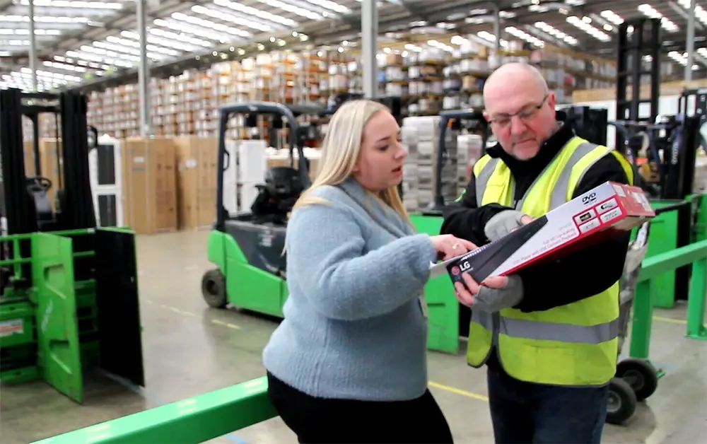 Young female apprentice with her supervisor at Appliances Online (AO)