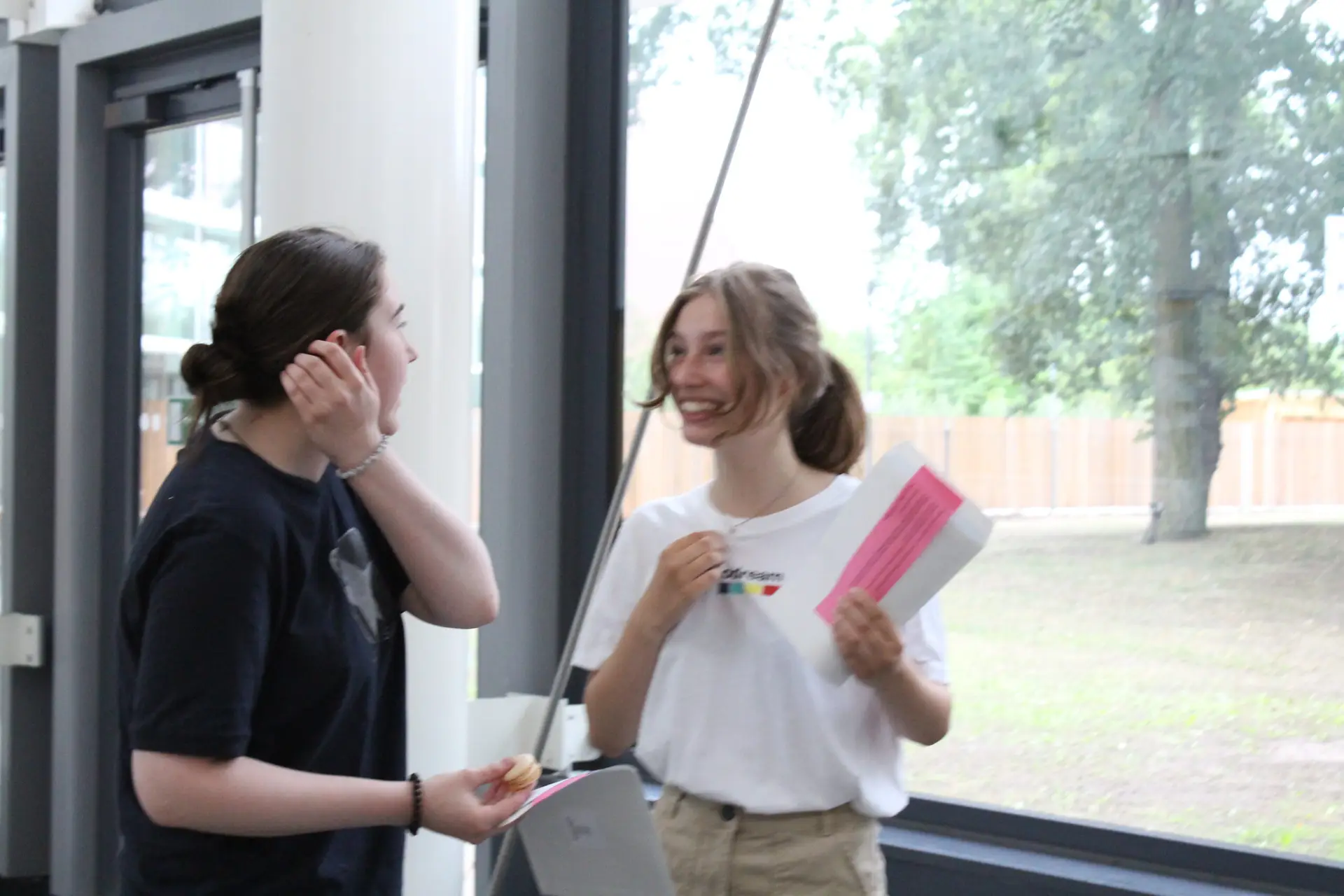 two students smiling with their results