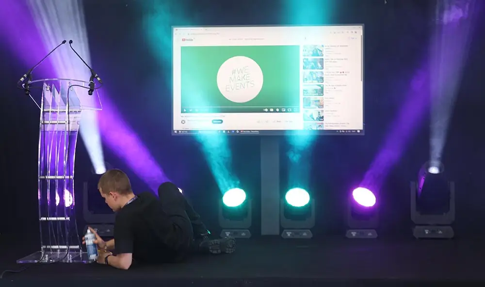 student adjusting lighting on the stage