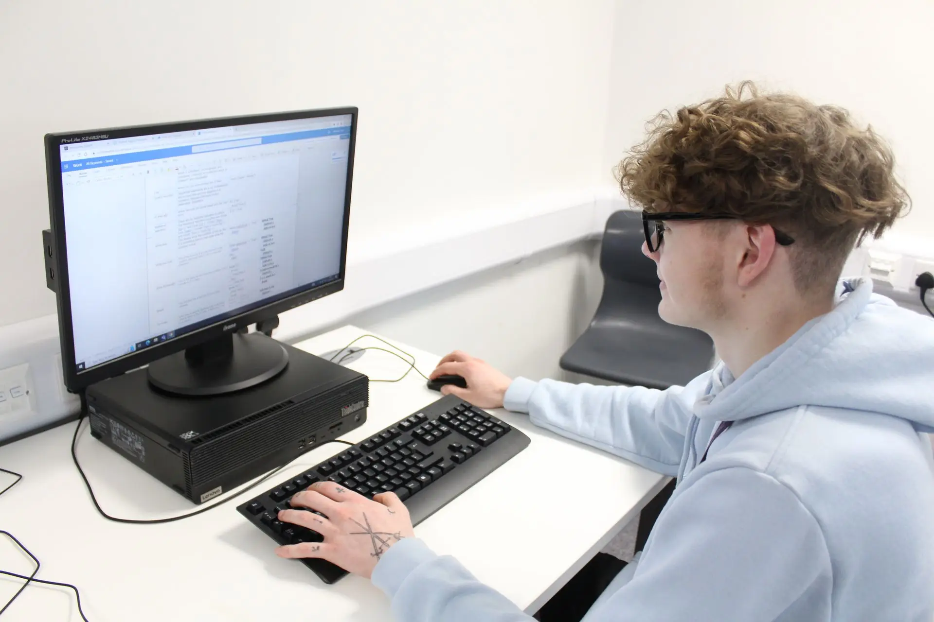 computing student at desk with computer