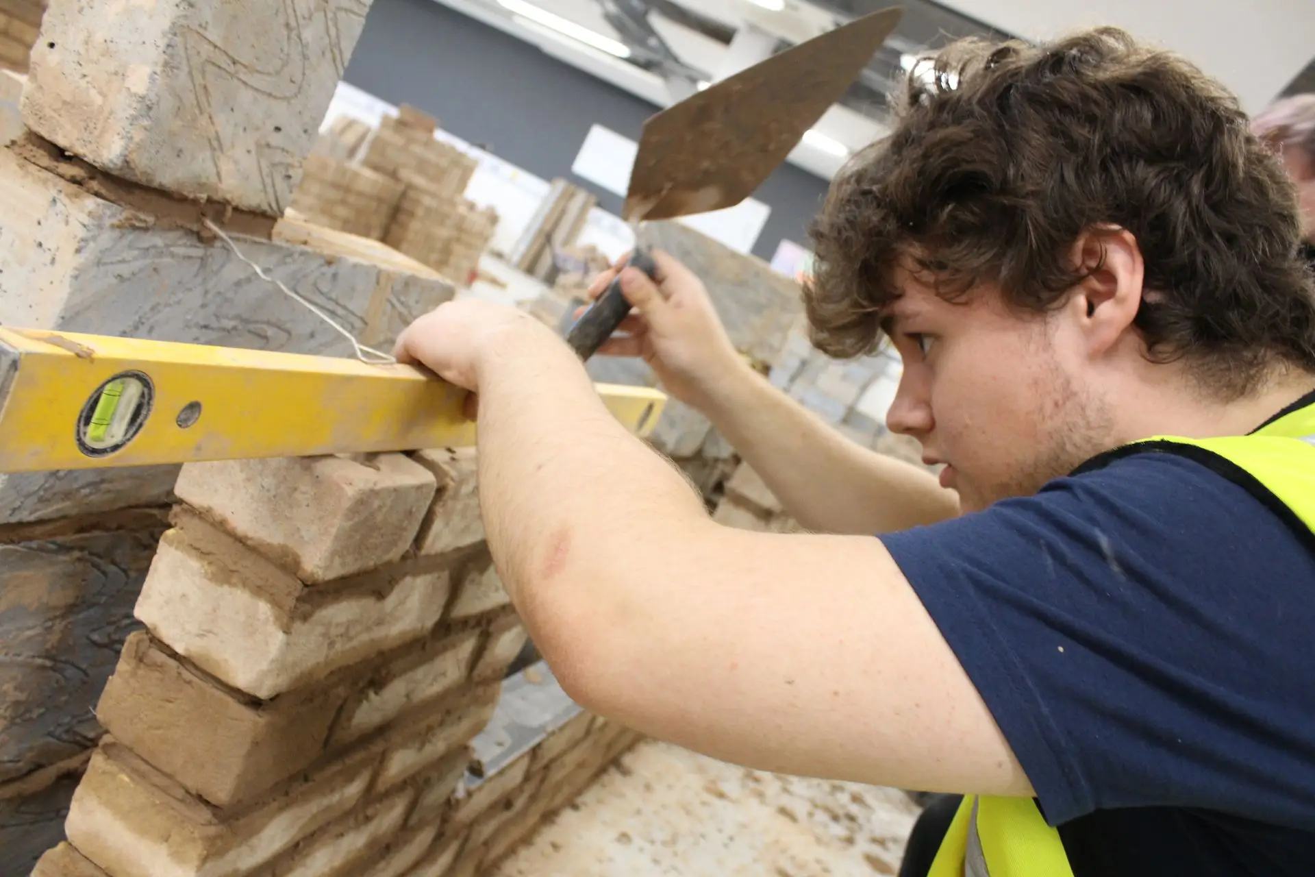construction student laying bricks