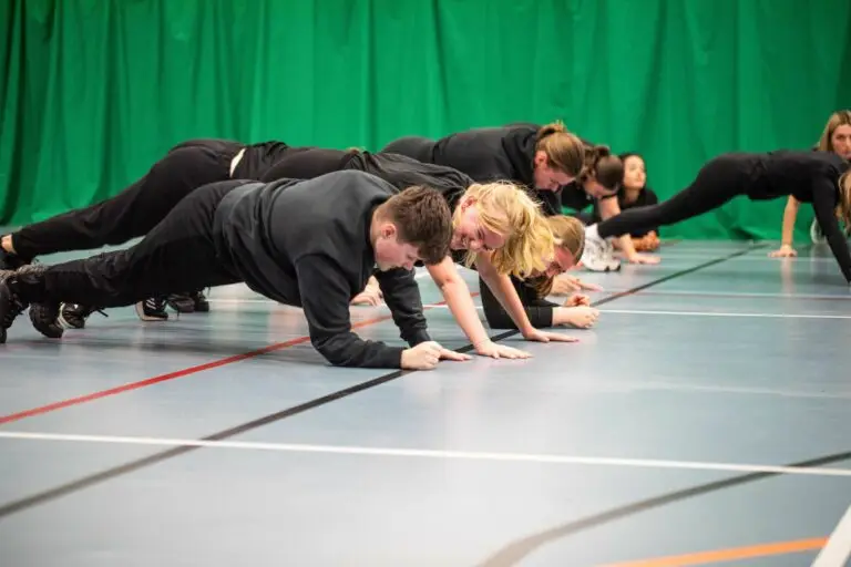 sport students doing push ups in the gym